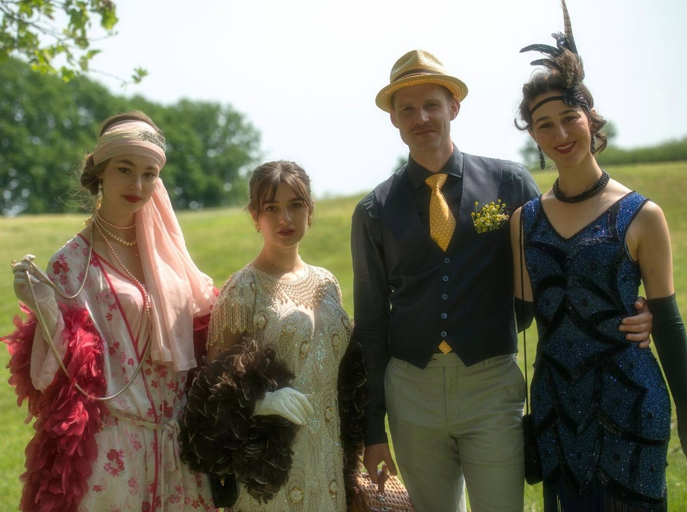 Group in Gatsby-era styling on a summer lawn